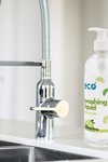 A bottle of eco dish soap bergamot lime by the kitchen sink, for an eco-friendly and sustainable home.